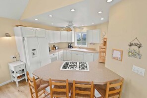 Enjoy cooking in this well-equipped kitchen with a central island, gas stove, and oven.