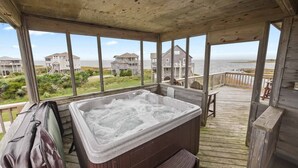 A wooden deck with a hot tub, overlooking a beach with houses. - Soundfront DogFriendly w Hot Tub, EV Charger, Private Sound Access, Beach Nearby (Frisco)