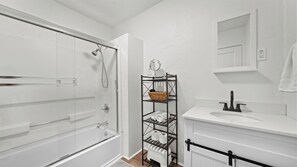 Combined shower/bathtub, hair dryer, towels, soap