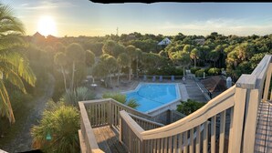 A pool area with a view of a river and surrounding greenery. - North Captiva Island- Ocean bay views and modern decor. Two new carts! (Captiva)