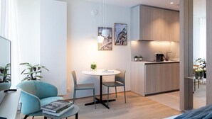 A modern apartment with a dining area, a kitchen, and a living space. - Deluxe Studio      . (Luxembourg)