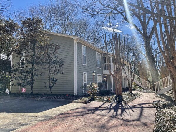 A two-story building with a brick pathway leading to the entrance.