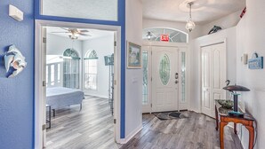 A hallway with a bed, a door with an 'EXIT' sign, and a small table with a lamp. - Bring your Boat & Enjoy Crystal River! Fish & See Manatee at Our Dock, Kayaks (Crystal River)