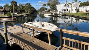 A calm canal with a dock and a boat moored at the dock. - Bring your Boat & Enjoy Crystal River! Fish & See Manatee at Our Dock, Kayaks (Crystal River)