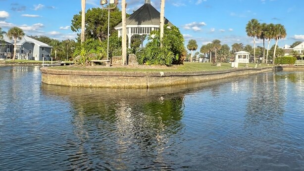 A serene waterfront property with a gazebo, palm trees, and a calm lake. - Bring your Boat & Enjoy Crystal River! Fish & See Manatee at Our Dock, Kayaks (Crystal River)