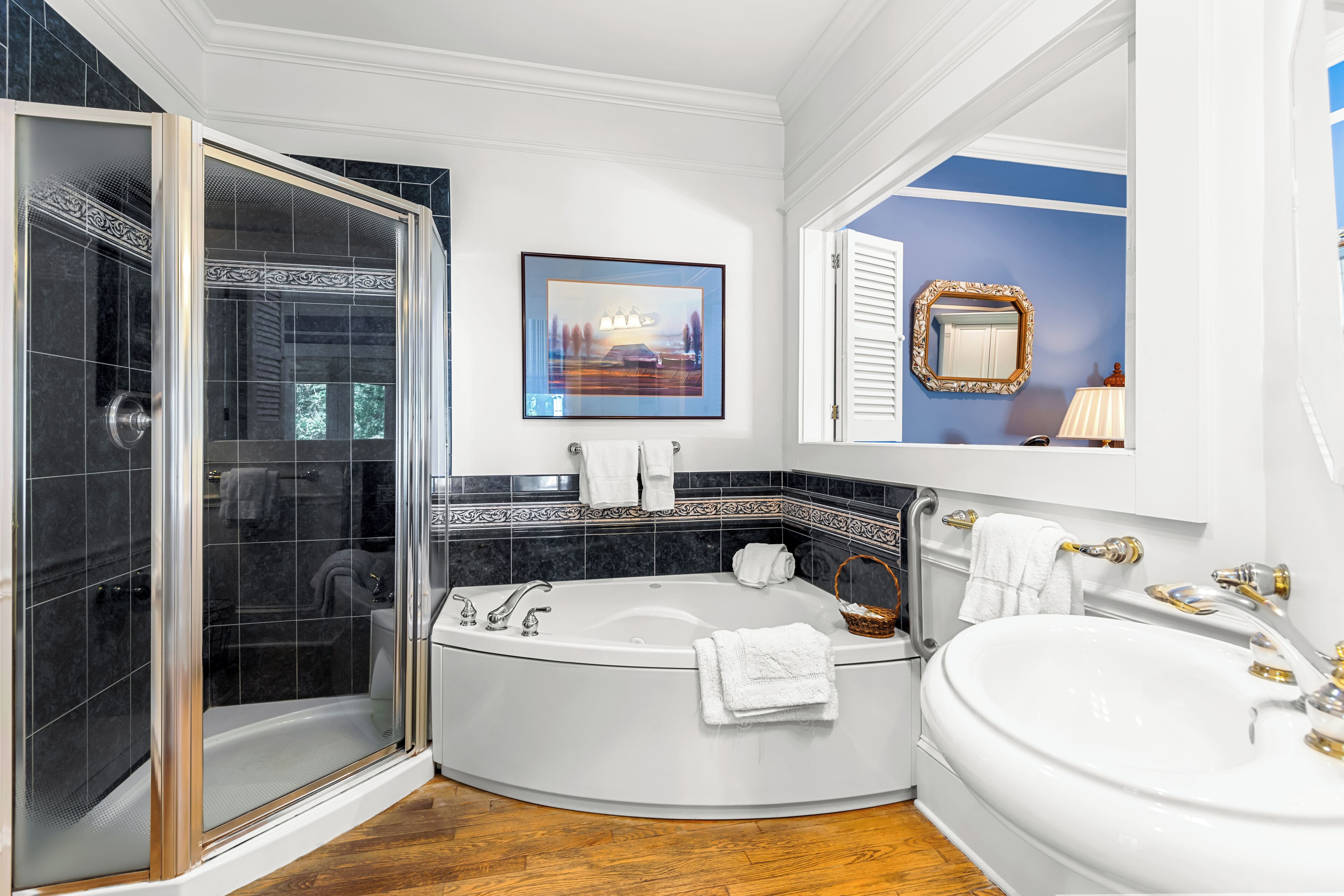 A bathroom with a walk-in shower, a freestanding bathtub, and a large sink.