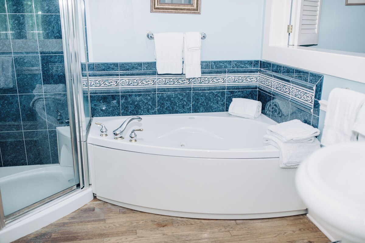 A bathroom with a bathtub, a shower, and a toilet.