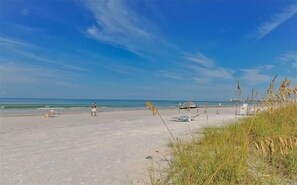 A beach with a clear sky, calm sea, and sparse vegetation. - Anchorage 305 - Siesta Chillin (Siesta Key)