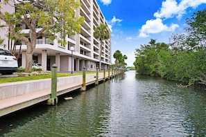 A waterfront hotel with a modern design, featuring a long, narrow building with multiple balconies.