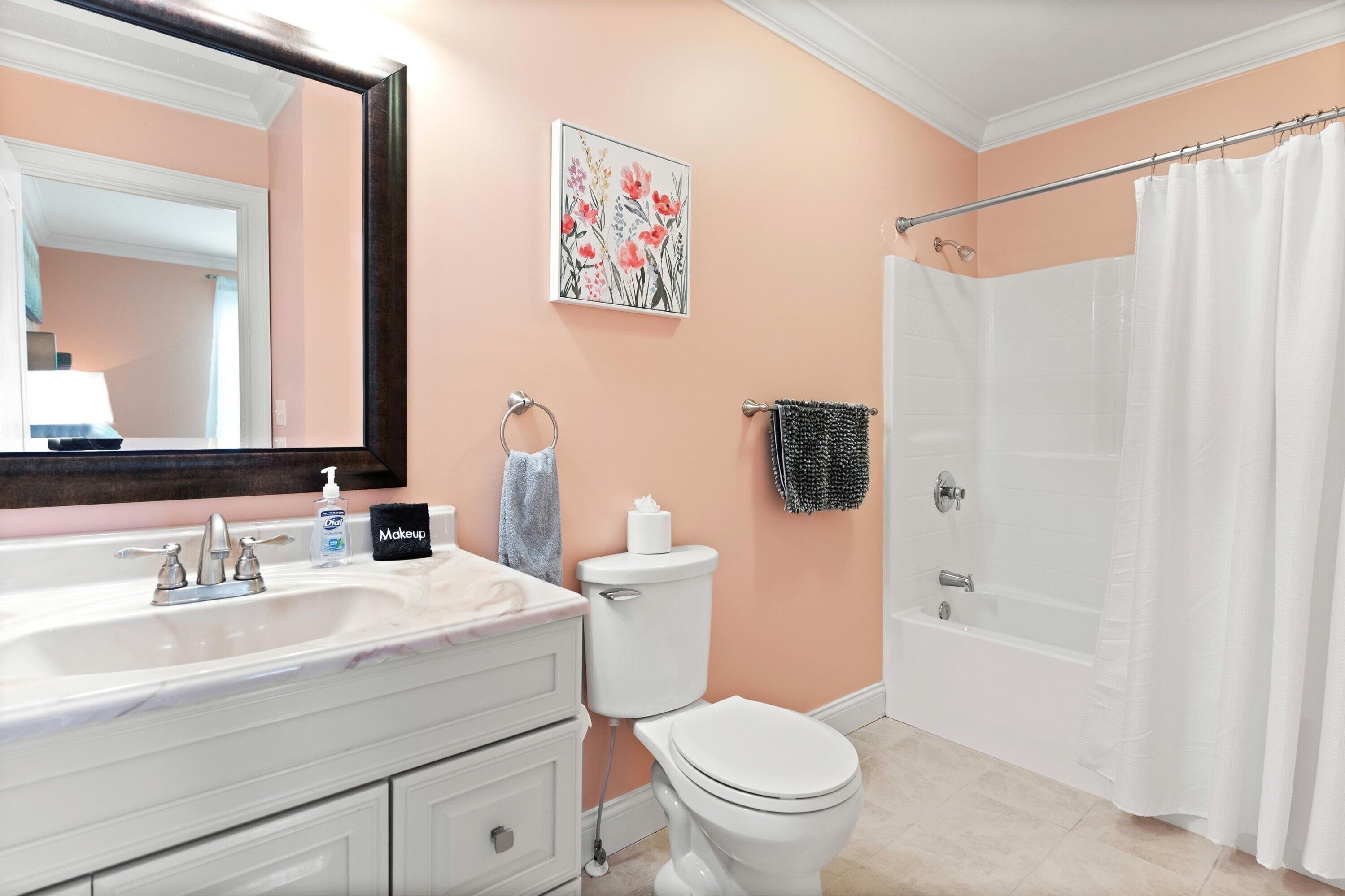 A bathroom with a sink, toilet, and shower curtain.