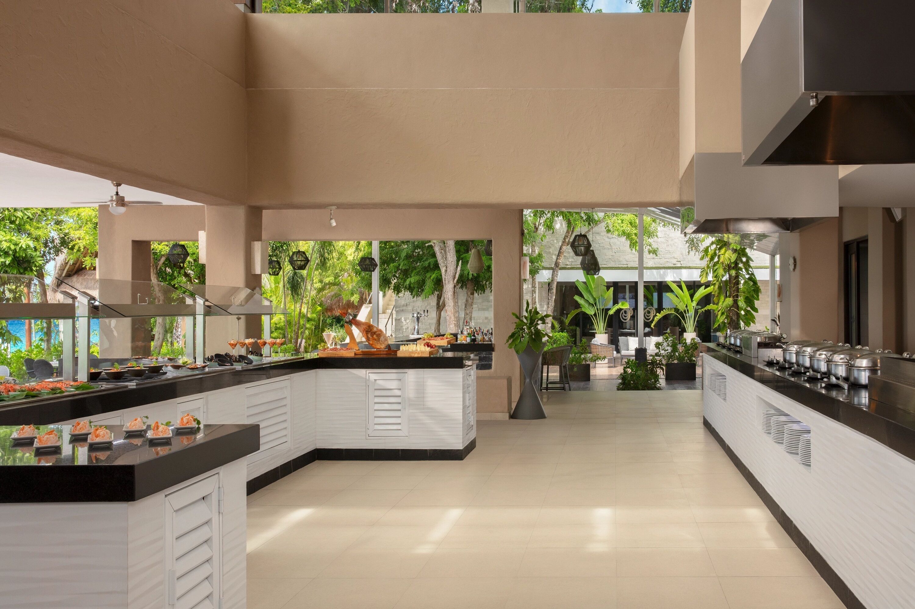 A modern kitchen with a central island, built-in appliances, and a view of the outdoors.