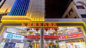 A hotel entrance with a sign for 'Loh Lin Hotel' and 'Good Spot' restaurant.