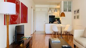 A modern living room with a flat-screen TV, wooden entertainment unit, and a sofa. - Palermo, Las Cañitas. In front of the Polo field. (Buenos Aires)
