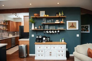A modern kitchen with wooden cabinets, a white countertop, and a coffee station. - The Toho-Tally Toho-Tel (Flagstaff)