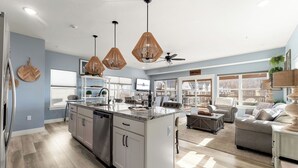 A modern kitchen with a central island, stainless steel appliances, and pendant lighting. - Lakeview Retreat with Private Firepit, Pinball, Backyard, Hot Tub, Free Tickets & Steps to Amenities (Branson)