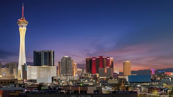 A city skyline with a prominent tower and several illuminated buildings.