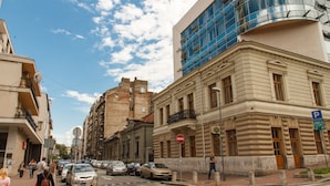 A street view with buildings, cars, and pedestrians. - Apartment Jovanova (Belgrade)