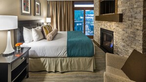 A hotel room with a large bed, a fireplace, a balcony with a view, and a modern design. - Stay and Ski in Northstar Resort (Truckee)