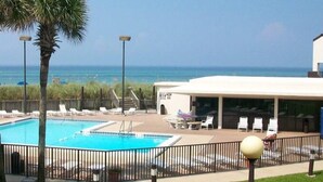 A pool area with lounge chairs and a view of the ocean. - Family&Pre-Approved Pet Friendly Condo Gated Complex Bed 3 Bath 3 walk2Tootsies (Panama City Beach)