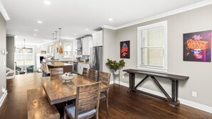 A modern kitchen with white cabinets, stainless steel appliances, and pendant lighting. - Walk to Broadway & Midtown • 5BR Townhouse Sleeps 12 • Private House Concert (Nashville)