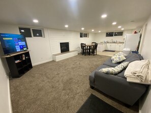 Smart TV, fireplace, books, computer monitors