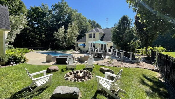 A backyard with a swimming pool, outdoor seating, and a fire pit. - Secluded retreat Heated pool 13 acres pool table playground (Union Pier)