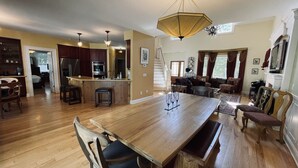 A spacious kitchen with wooden flooring, a central island, and modern appliances. - Secluded retreat Heated pool 13 acres pool table playground (Union Pier)