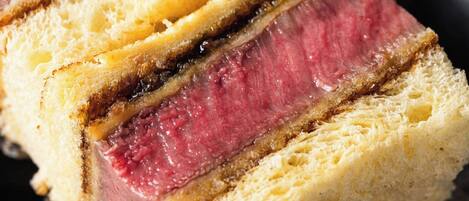 A slice of meatloaf on a piece of bread.