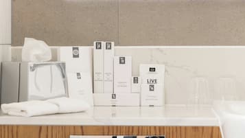 A bathroom counter with toiletries and a mirror.