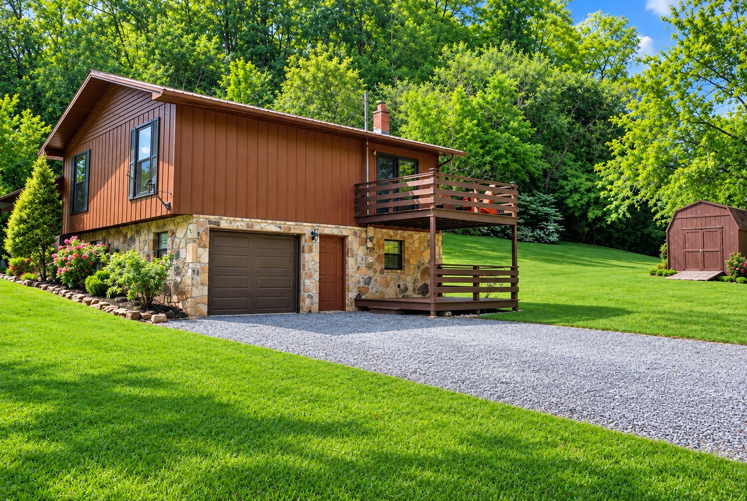A two-story house with a stone foundation, a wooden deck, and a garage.