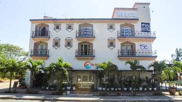 Stunning hotel with a symmetrical facade and covered entrance.