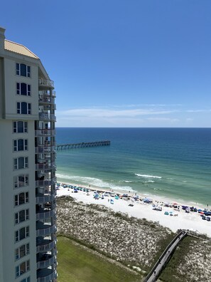 A high-rise hotel overlooking a beach with a pier extending into the ocean. - "Luxurious Gulf-Front Condo" Watch the Dolphins Play from Your Private Balcony (Navarre)