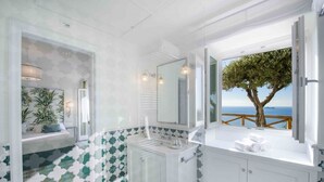 A bathroom with a large window, a sink, a mirror, and a view of the sea. - MyExclusiveItaly - Exclusive Villa in Praiano with Pool & View (Praiano)
