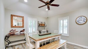 A dining area with a wooden table, white chairs, a bench, a ceiling fan, a clock, and a window with blinds. - 'Leaping Toad Ranch' ~ 9 Mi to Lake Granbury! (Granbury)