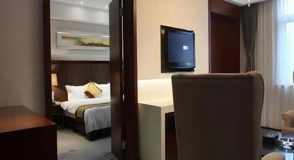 A hotel room with a bed, a desk, a chair, a television, and a window with curtains. - Greentree Alliance Hotel Tongcheng Tong'an Road Beidao (Anqing)