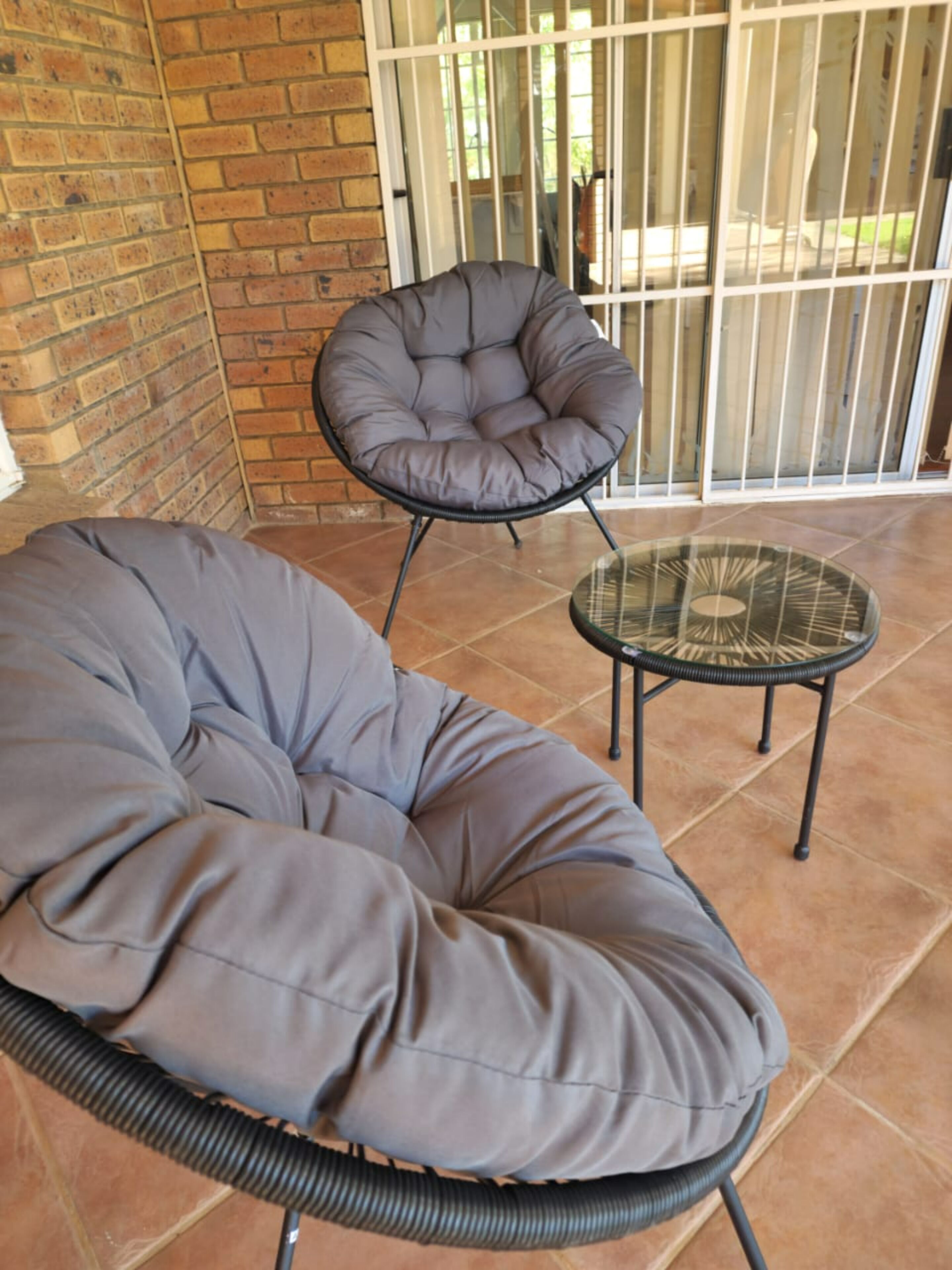 A room with a large, cushioned seating area and a small table.