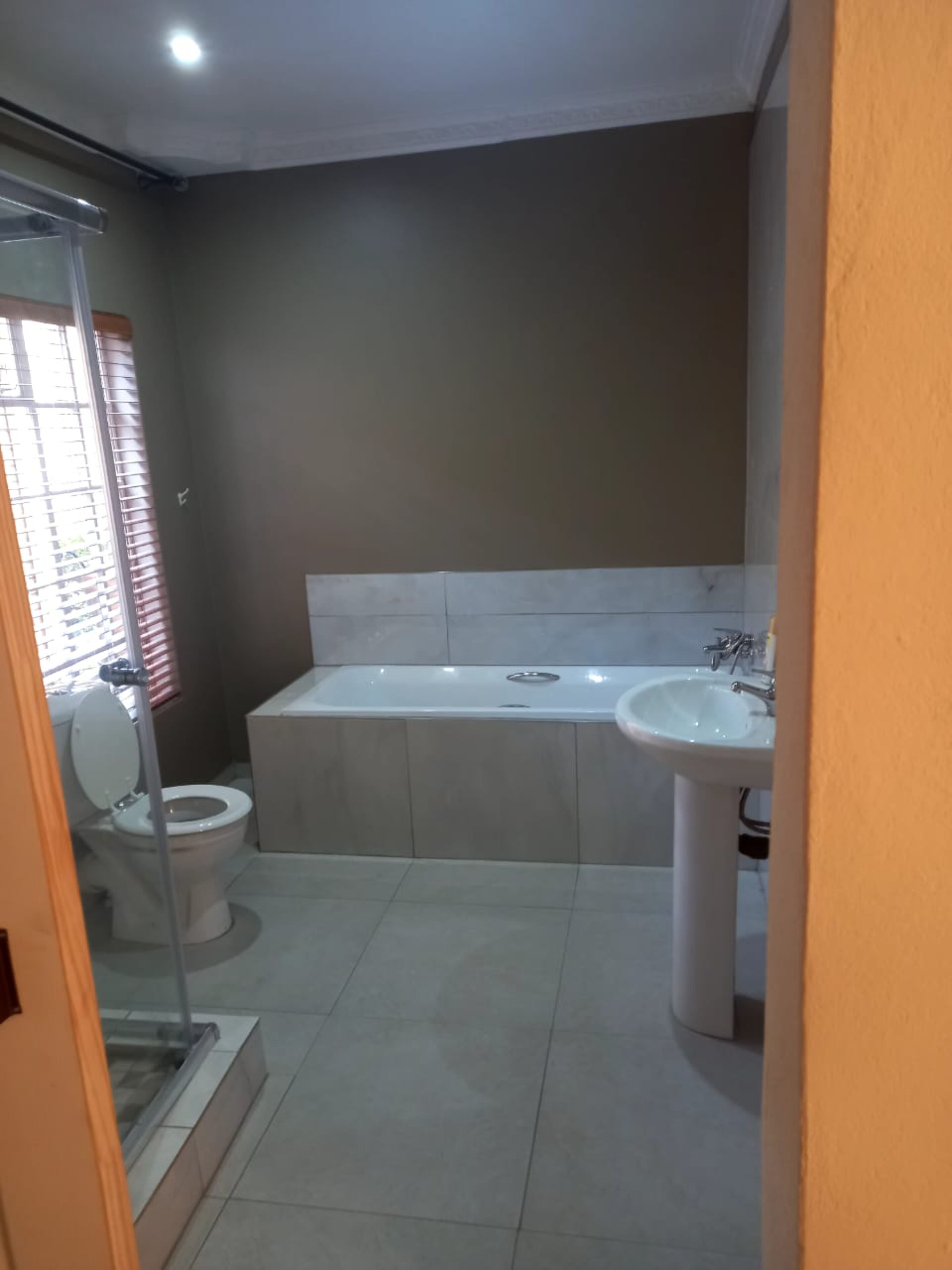 A bathroom with a toilet, bathtub, and sink.