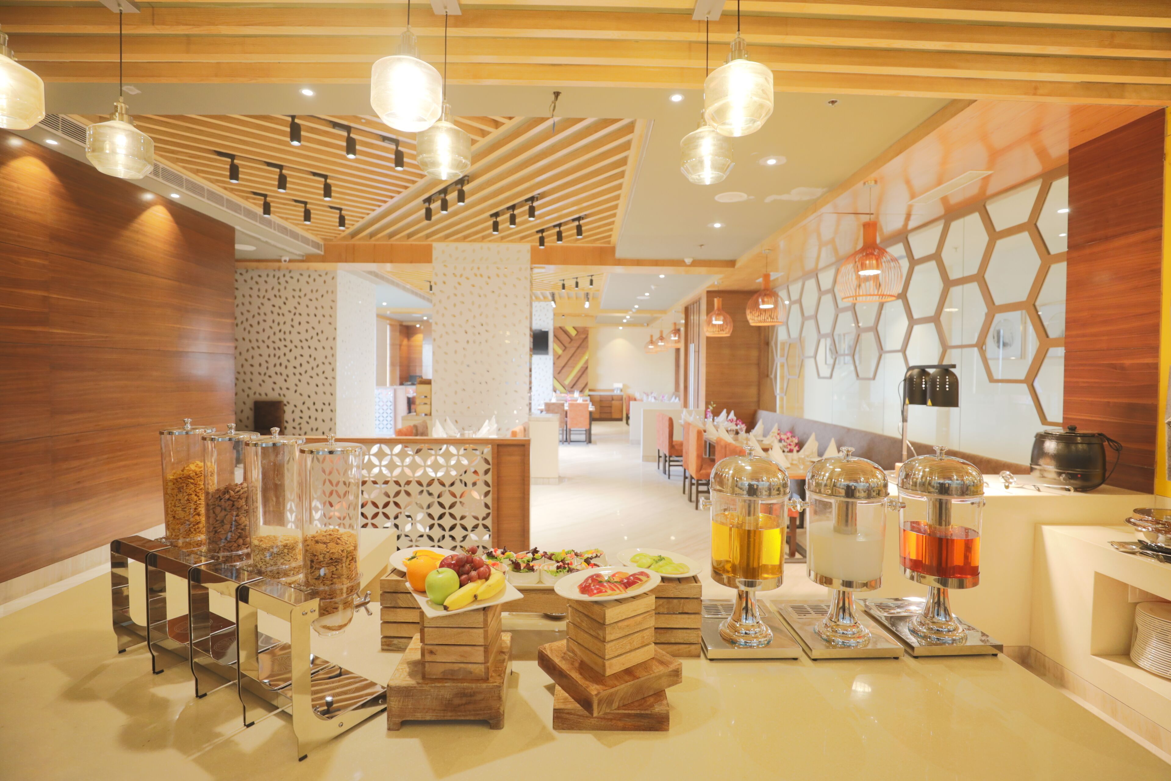 A buffet area with various food items and drink dispensers.