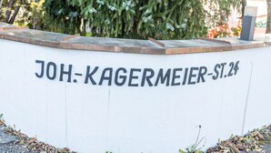 A white wall with the text 'JOH-KAGERMEIER-ST.24' in black letters.