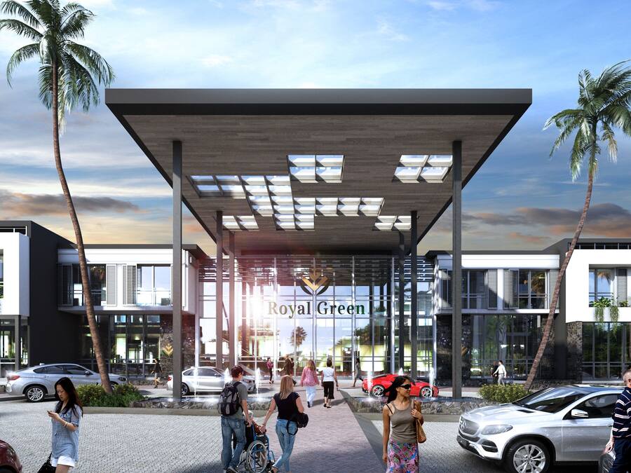 A modern building with a covered entrance, palm trees, and people walking around.