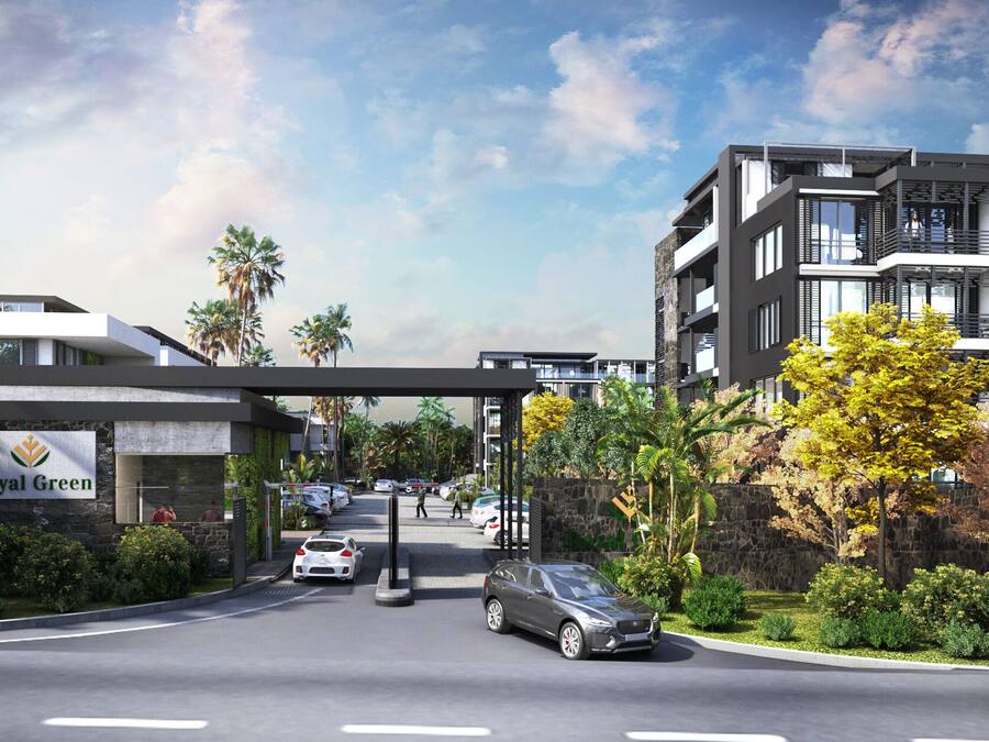 A modern hotel entrance with a covered walkway, a sign reading "Royal Green," and a parking area with cars.
