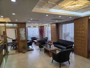 A modern hotel lobby with a reception desk, seating area, and large windows. - Hotel La SERA (Istanbul)