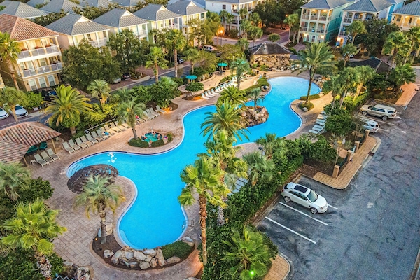 Resort style lagoon pool with hot tub. Pool area is also equipped with two waterfalls & self serve tiki bar