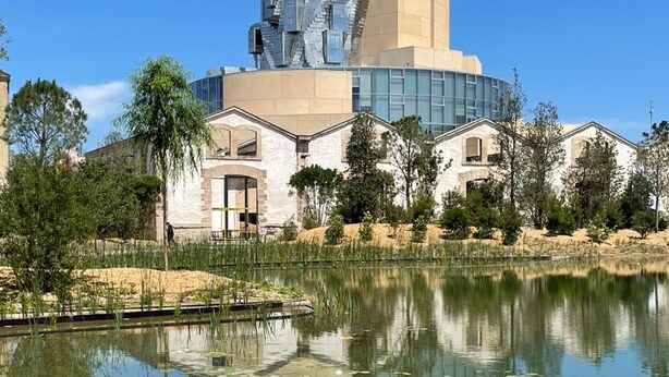 A modern building with a unique architectural design, featuring a central tower and surrounding structures. - Townhouse Terrace Beauduc, Arles (Arles)