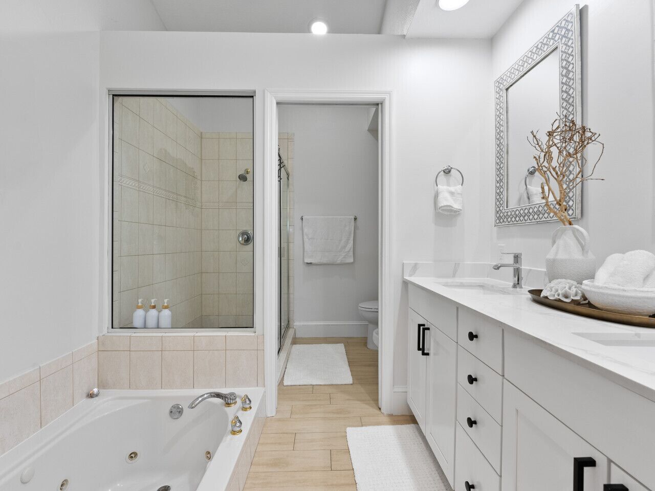 A modern bathroom with a bathtub, a shower, and a sink.