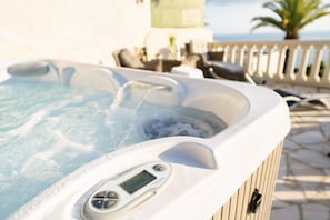 A hot tub with a digital control panel, surrounded by outdoor furniture and a railing. - Unique Villa Boron! Sea view, swimming pool and Jacuzzi (Nice)