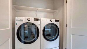 A laundry room with two white front-loading washing machines. - Alpine Adventure Haus! 4BR Townhome 15m to Main (Heber City)