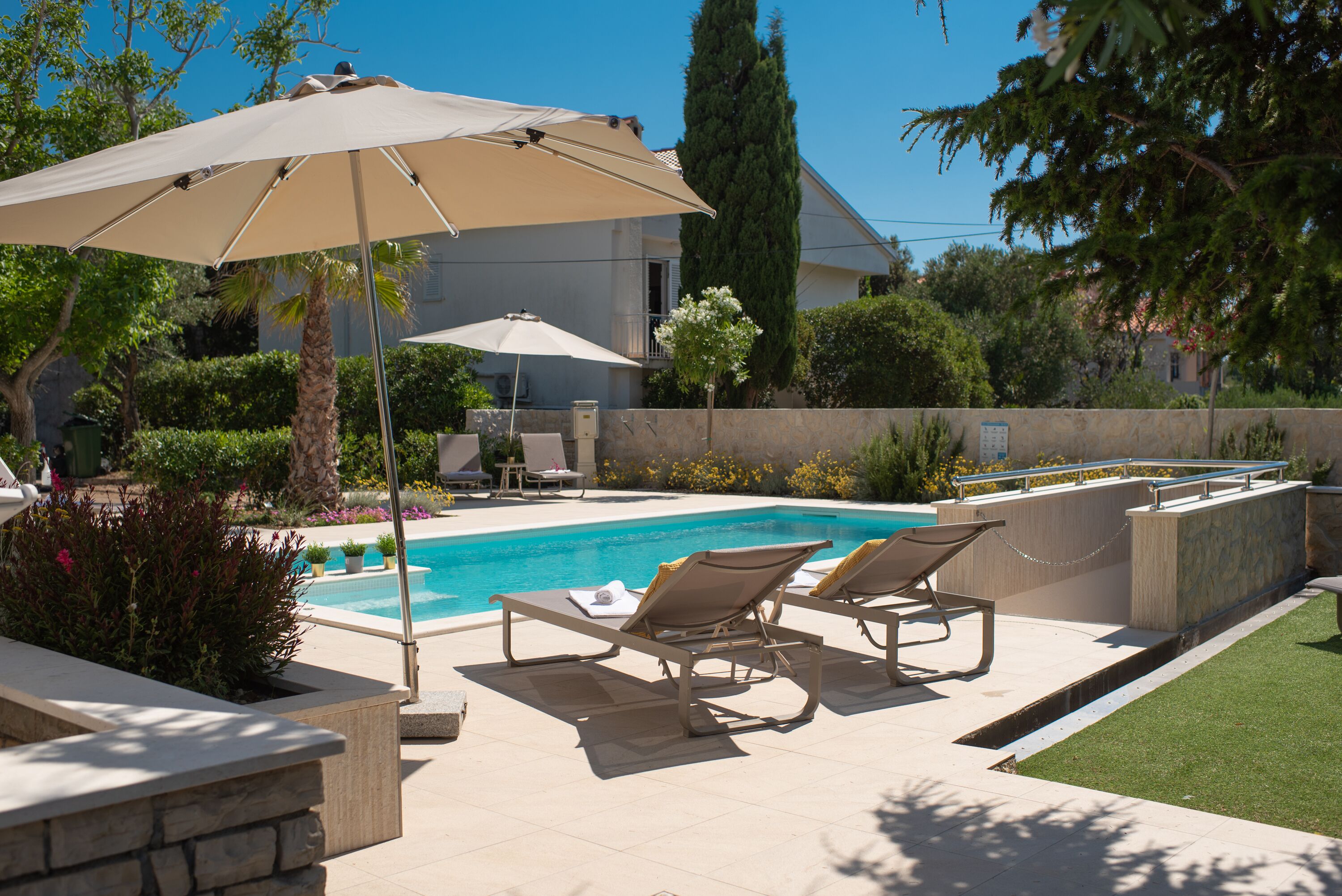 Seasonal outdoor pool, open 9:00 AM to 9:00 PM, pool umbrellas