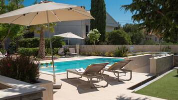 Seasonal outdoor pool, open 9:00 AM to 9:00 PM, pool umbrellas