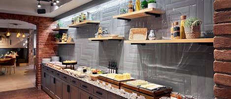 A modern kitchen with granite countertops, wooden shelves, and a brick accent wall.